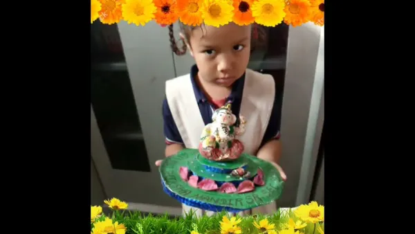A student with her Ganesh idol